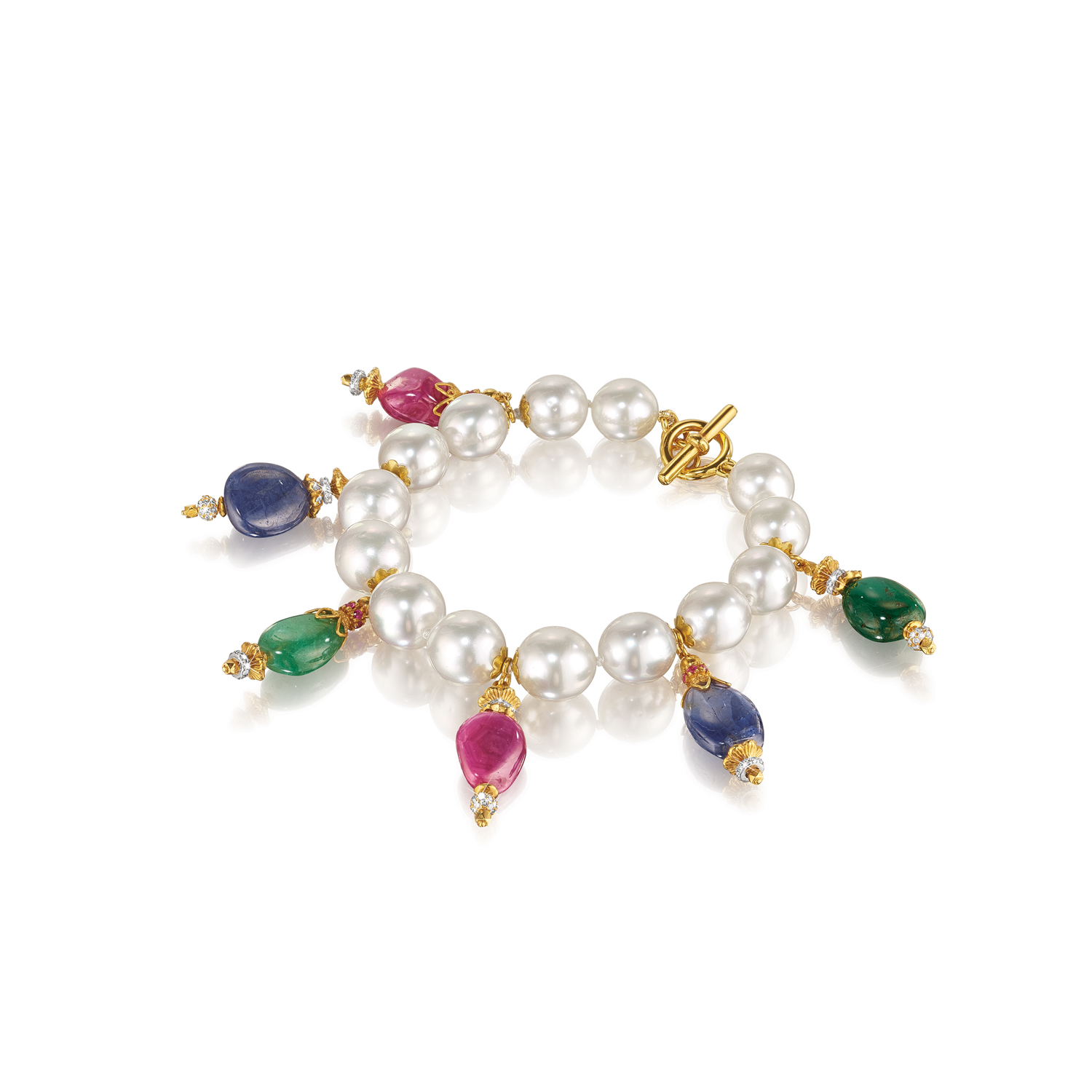 Inspired by the richly hued mosaics and gold-encrusted treasures of the Byzantine Empire, Verdura set gems into gold like tiles, mixing precious and semi-precious stones in various colors and cuts. South Sea cultured pearl, sapphire, emerald, ruby, diamond, gold and sterling silver